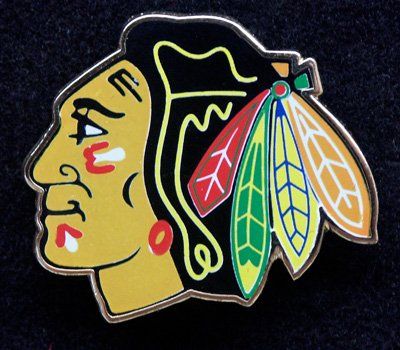 A colorful pin with a native american face on it