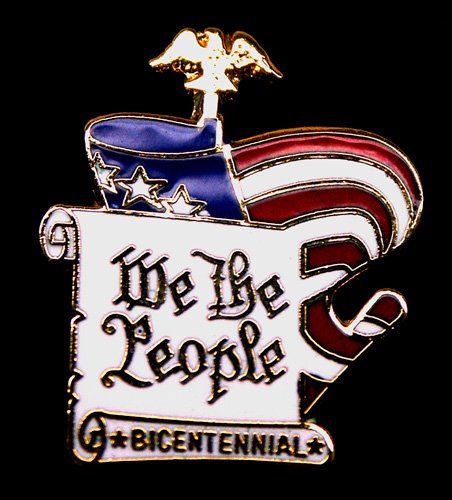 A pin that says we the people on it