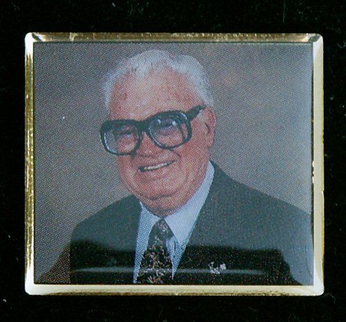 A picture of a man wearing glasses and a suit