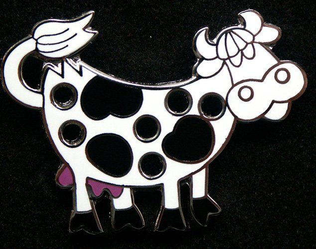 A black and white cow with a flower on its head