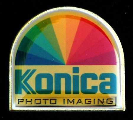 A pin that says konica photo imaging on it