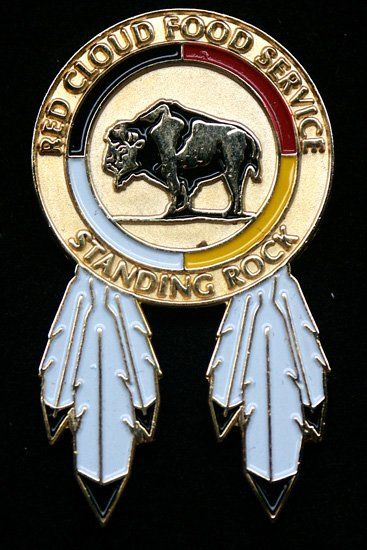 A red cloud food service standing rock pin with a bison in the center