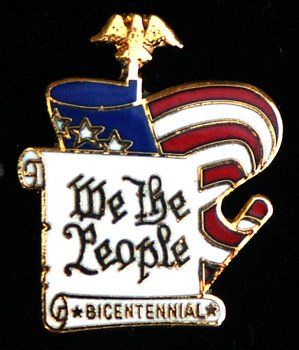 A pin that says we the people on it