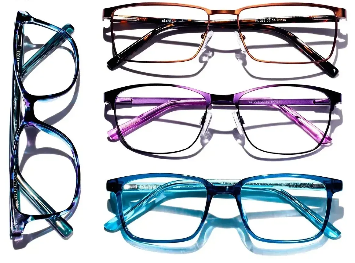 Four different pairs of glasses are sitting on top of each other on a white surface.
