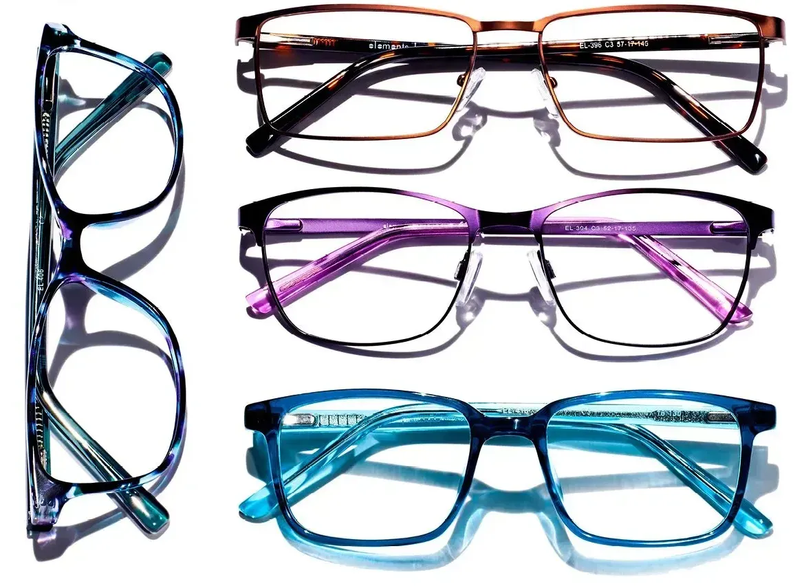 Three pairs of glasses are sitting on top of each other on a white surface.
