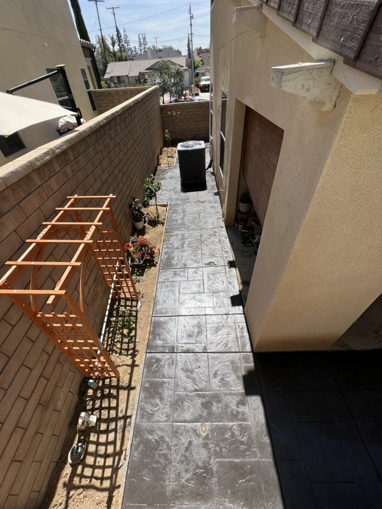 An aerial view of a sidewalk leading to a house