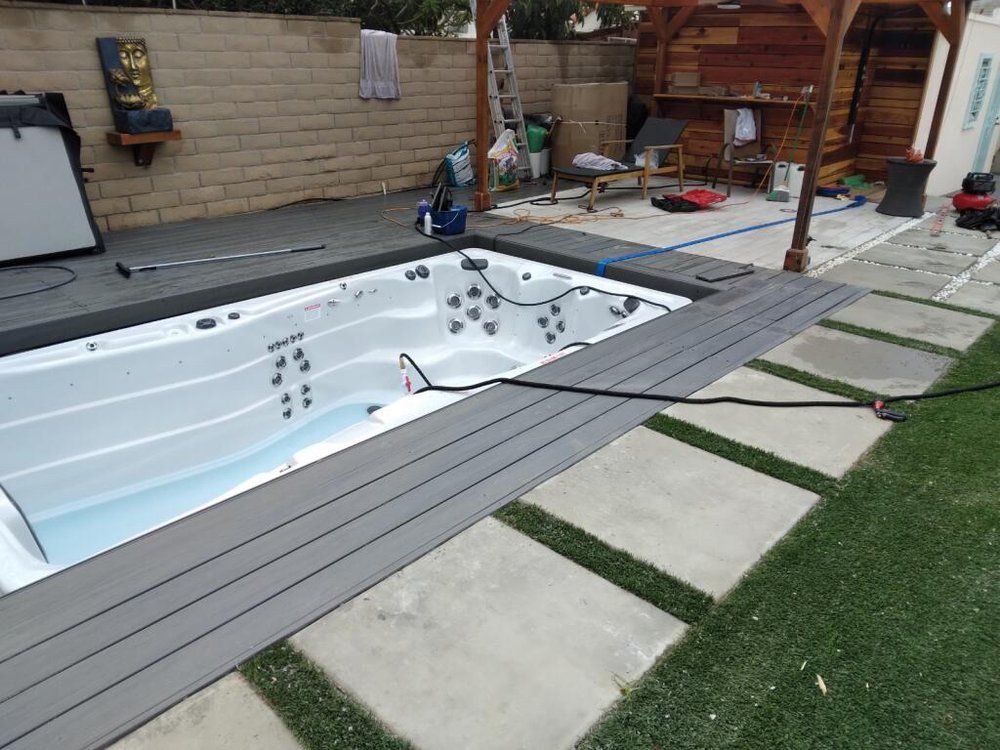 A swimming pool is being built in the backyard of a house.