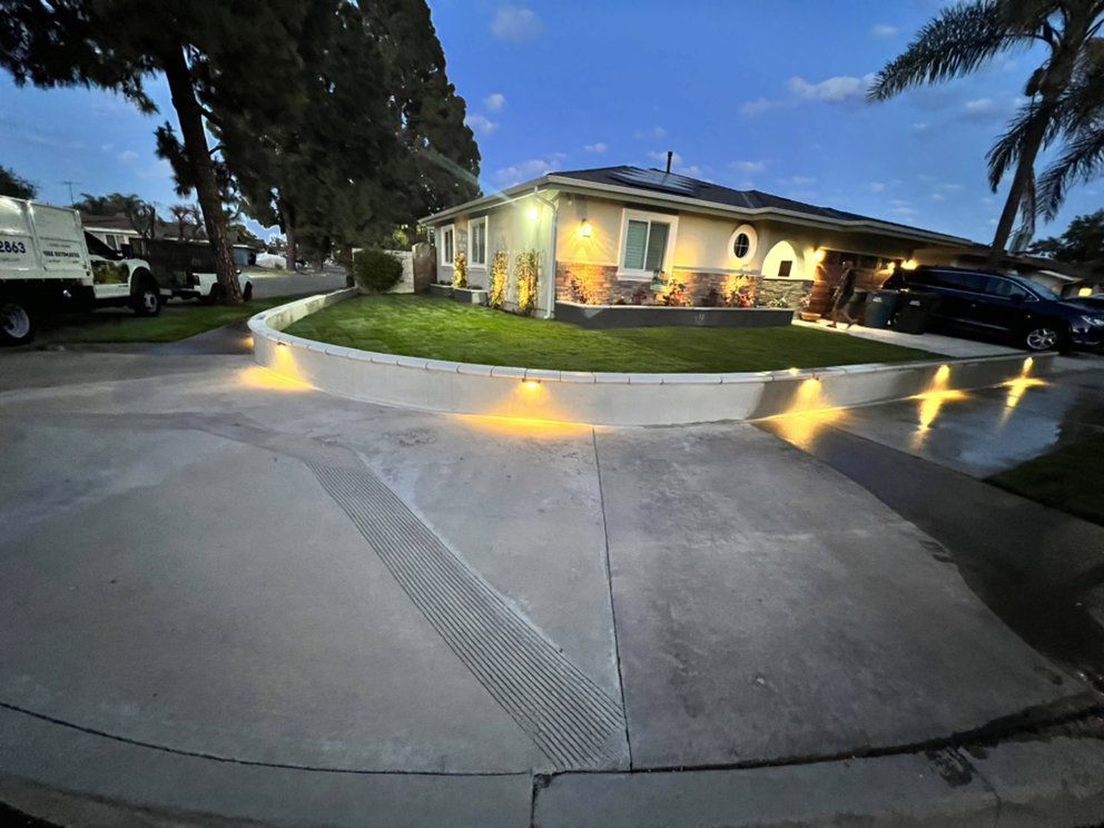 A house with a lot of lights on the driveway