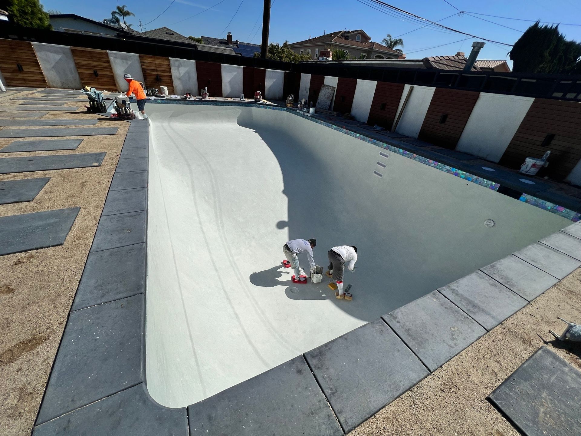 There is a pergola in the backyard of a house.