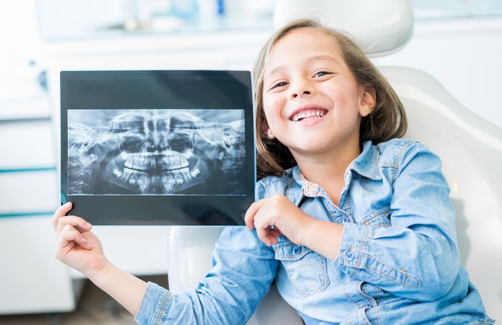 Kid Holding Dental X-ray — Novi, MI — Olde Orchard Pediatric