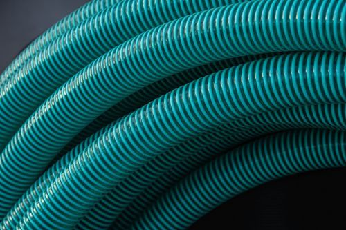 Close-up view of textured green industrial machine hoses.