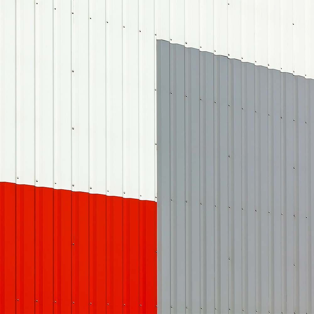 Red, white, and gray corrugated metal building exterior.