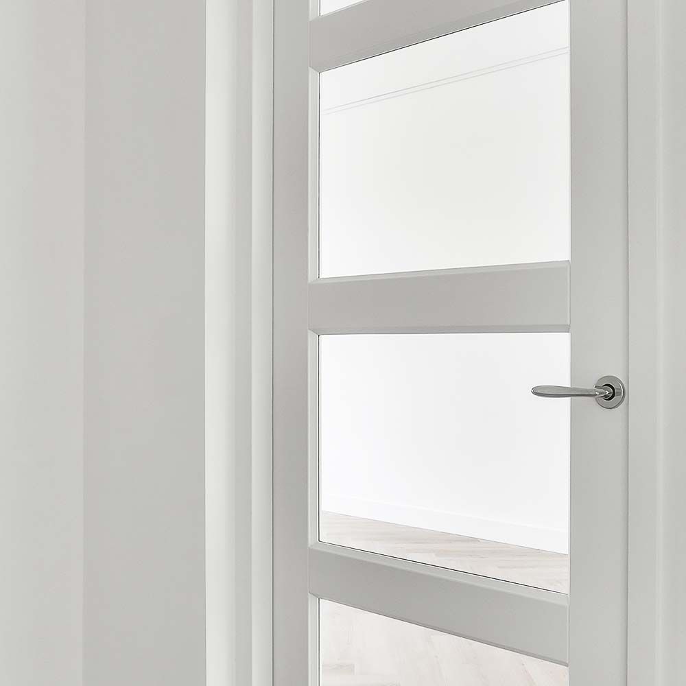 White interior door with glass panels and silver handle.
