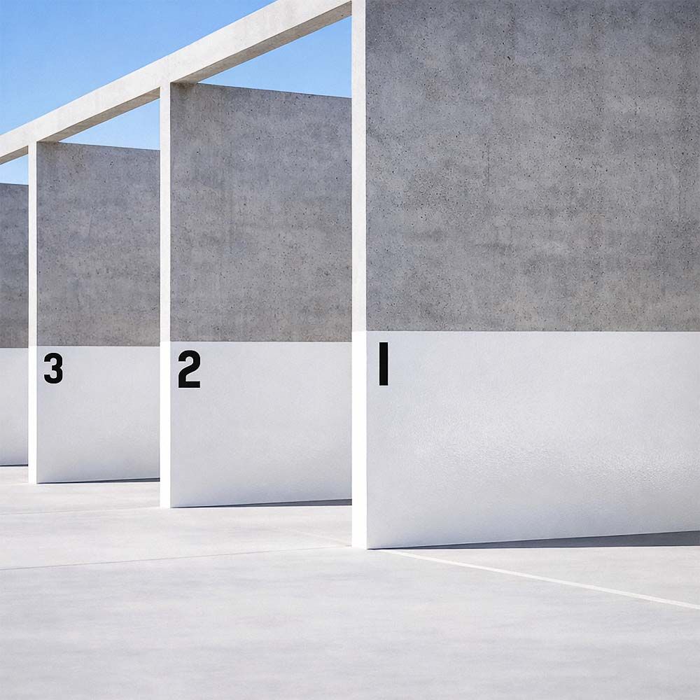 Concrete walls, numbered 1-3, with white bottoms, under a bright blue sky.