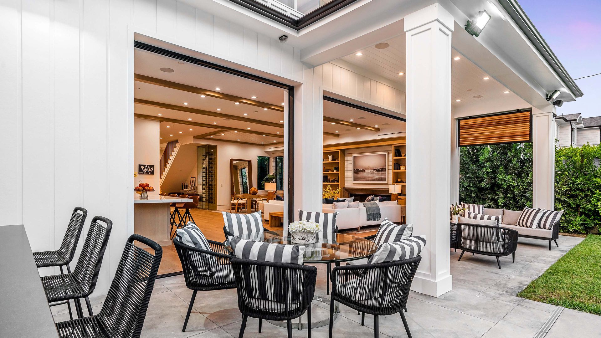 Outdoor patio with seating area, open to a luxurious interior.