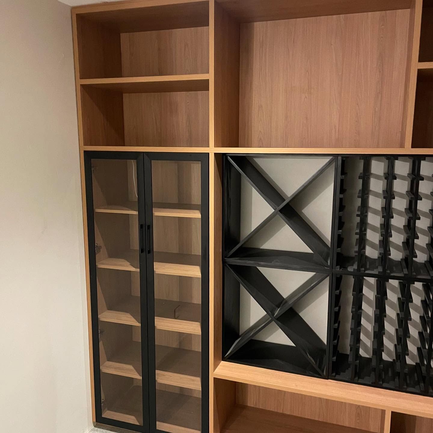 White bathroom vanity with drawers, open shelves, and faucet against a white wall and tiled floor. — Maken Kitchens & Cabinets in Byron Bay, NSW
