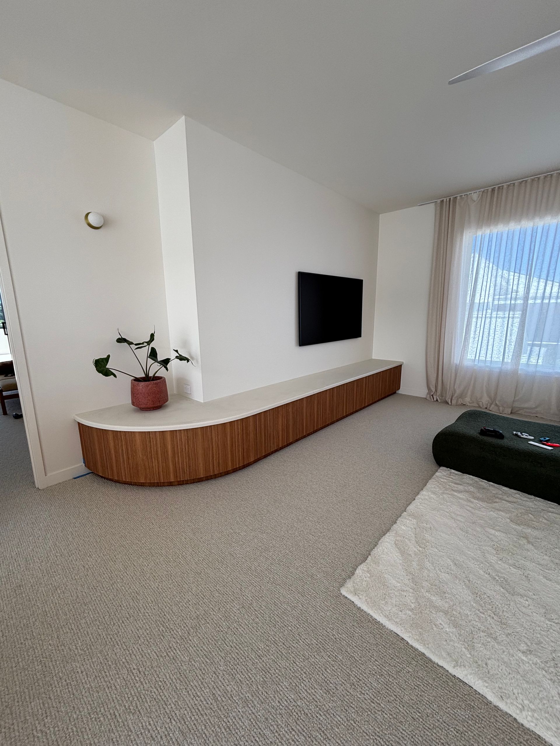 Modern Living Room With a Long, Wood-paneled Media Console Under a Mounted Tv — Maken Kitchens & Cabinets in Chinderah, NSW
