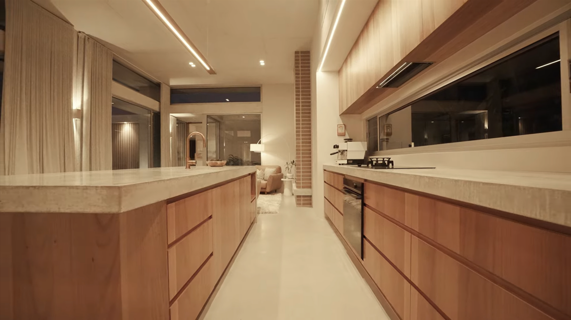 Modern kitchen with light wood cabinets, light countertops, and large window — Maken Kitchens & Cabinets in Chinderah, NSW