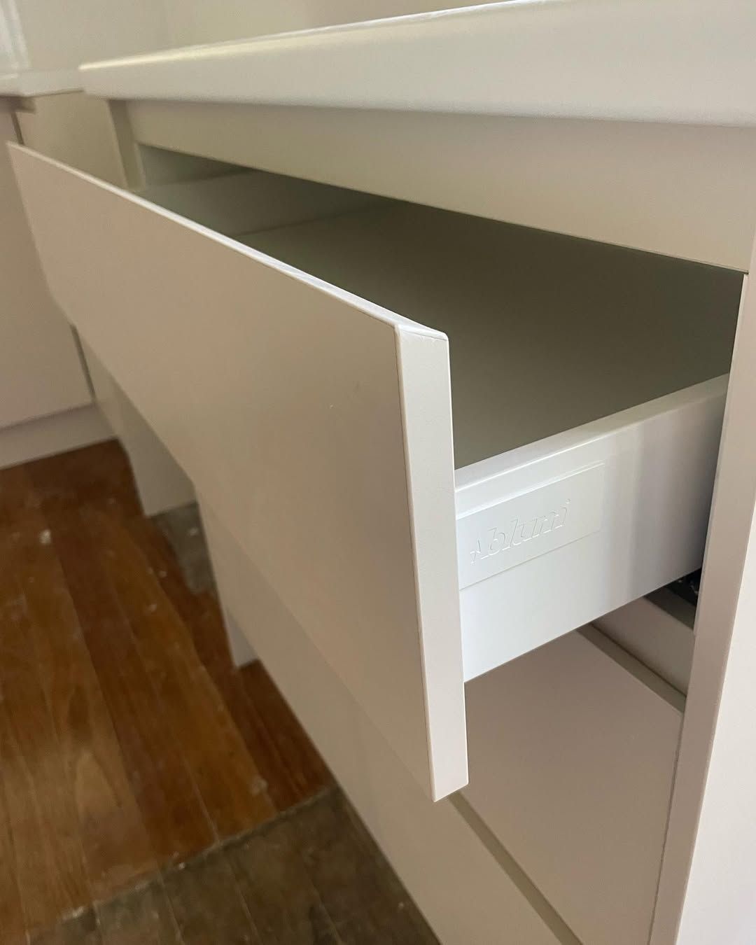 White kitchen drawer partially open, revealing empty interior. — Maken Kitchens & Cabinets in Lismore, NSW