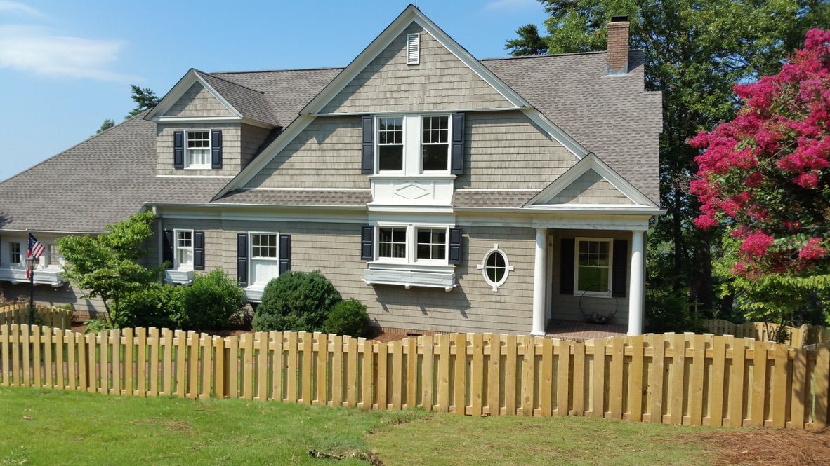 A large house with a wooden fence around it