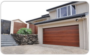 Double storey home with a wooden grain painted aluminium sectional garage door