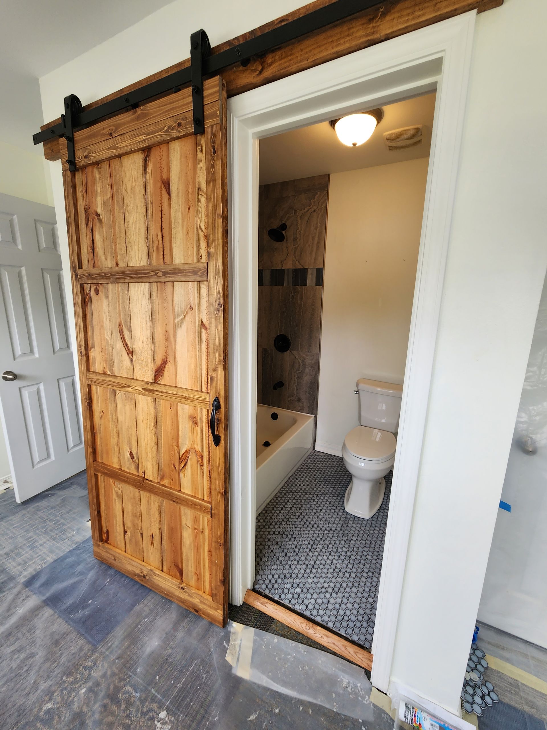 A wooden fence with a gate in the backyard of a house.