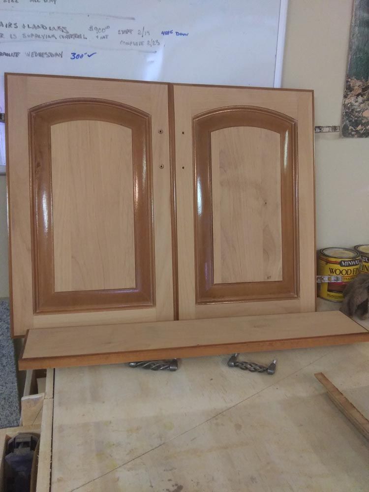 A pair of wooden cabinet doors sitting on a table