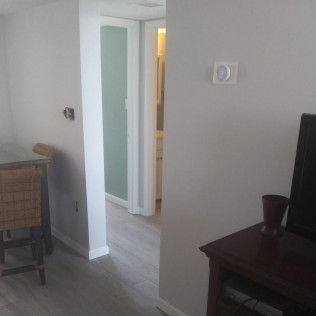A living room with a table and chairs and a television.