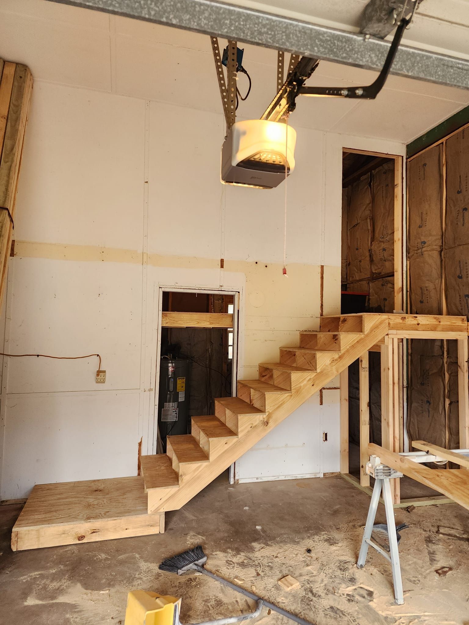 A wooden staircase is being built in a garage
