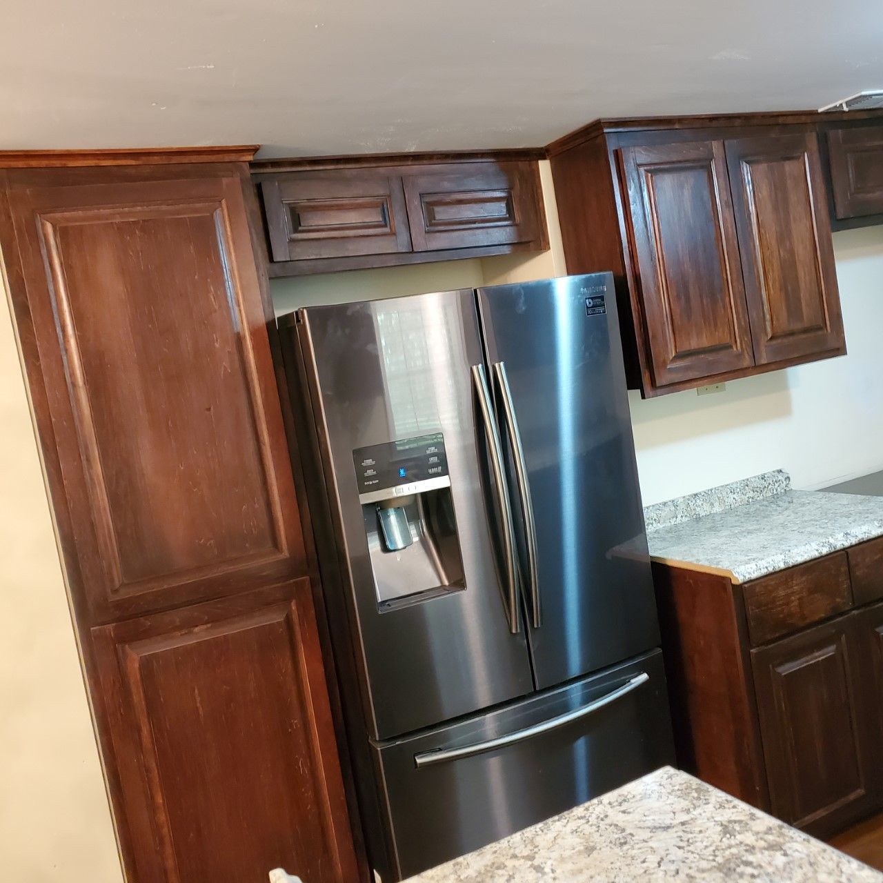 A kitchen with stainless steel appliances and wooden cabinets