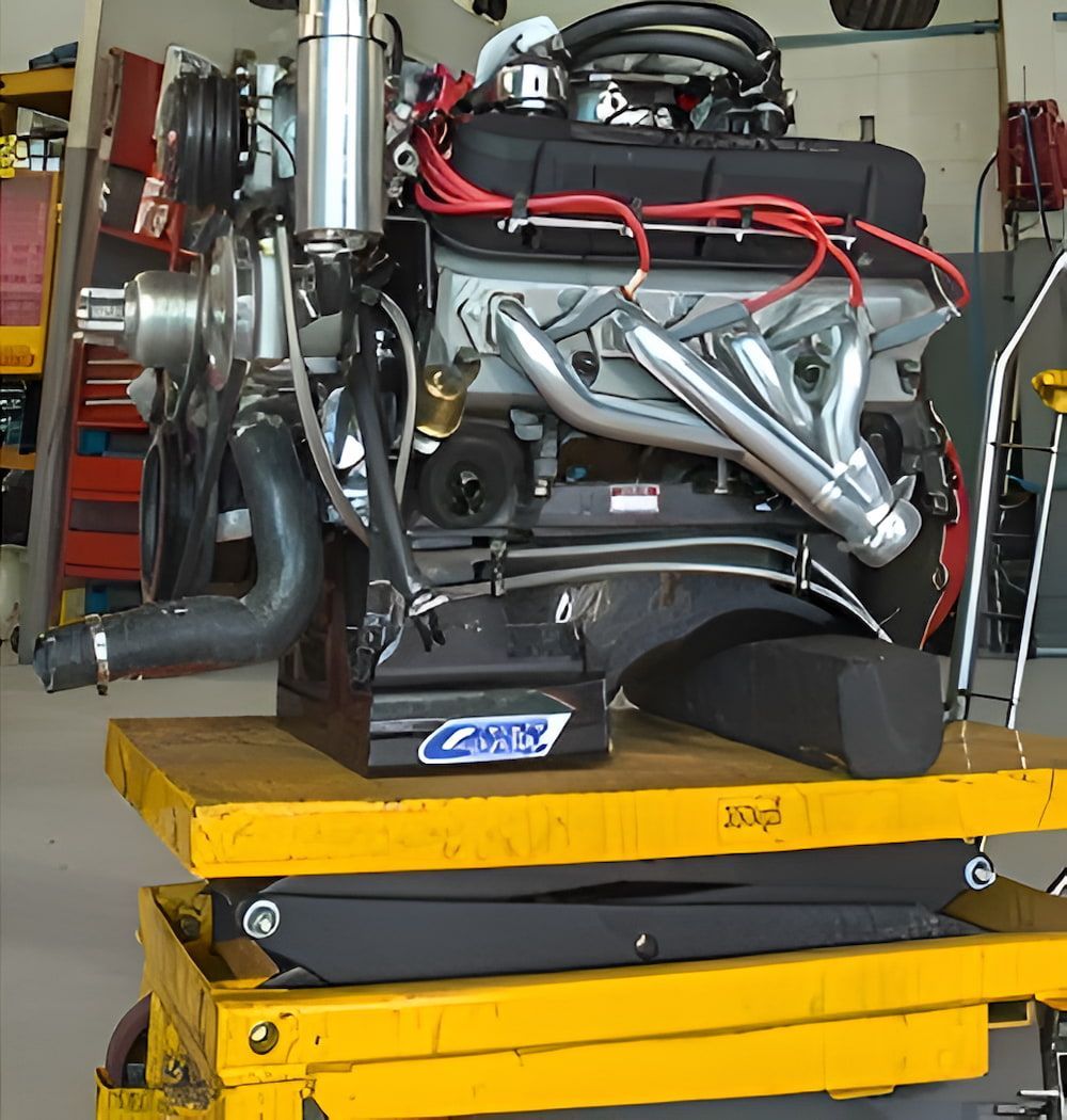A Car Engine Is Sitting On Top Of A Yellow Cart — Hunter Automotive In Bungalow, QLD