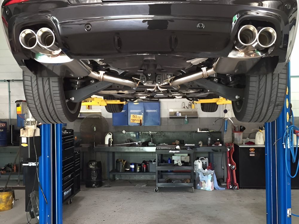 A Car Is Sitting On A Lift In A Garage — Hunter Automotive In Bungalow, QLD