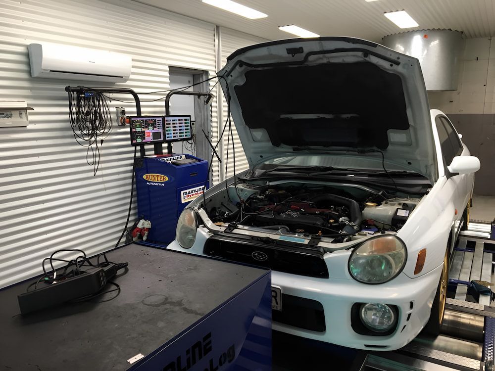 A White Car With The Hood Up Is Being Tested In A Garage — Hunter Automotive In Bungalow, QLD