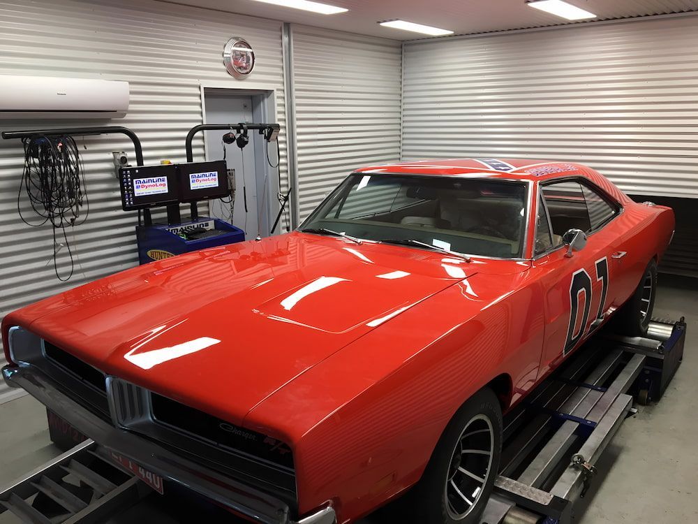 A Red Dodge Charger Is Parked In A Garage — Hunter Automotive In Bungalow, QLD