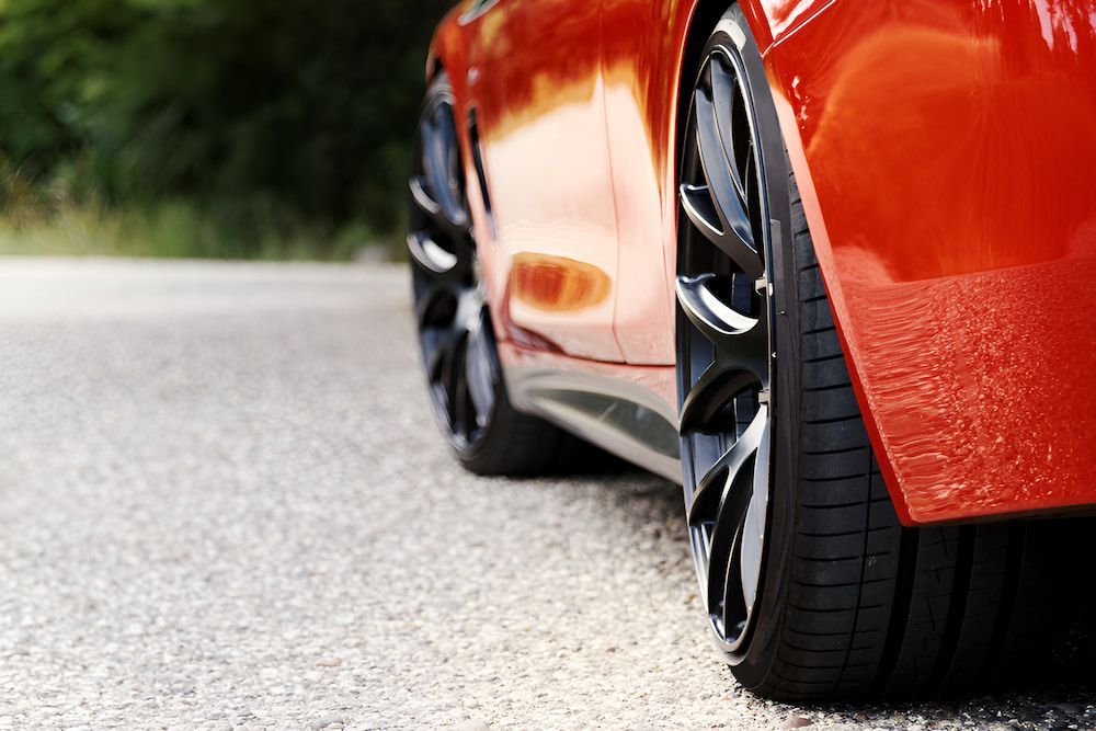 A Red Sports Car Is Parked On The Side Of The Road — Hunter Automotive In Tablelands, QLD