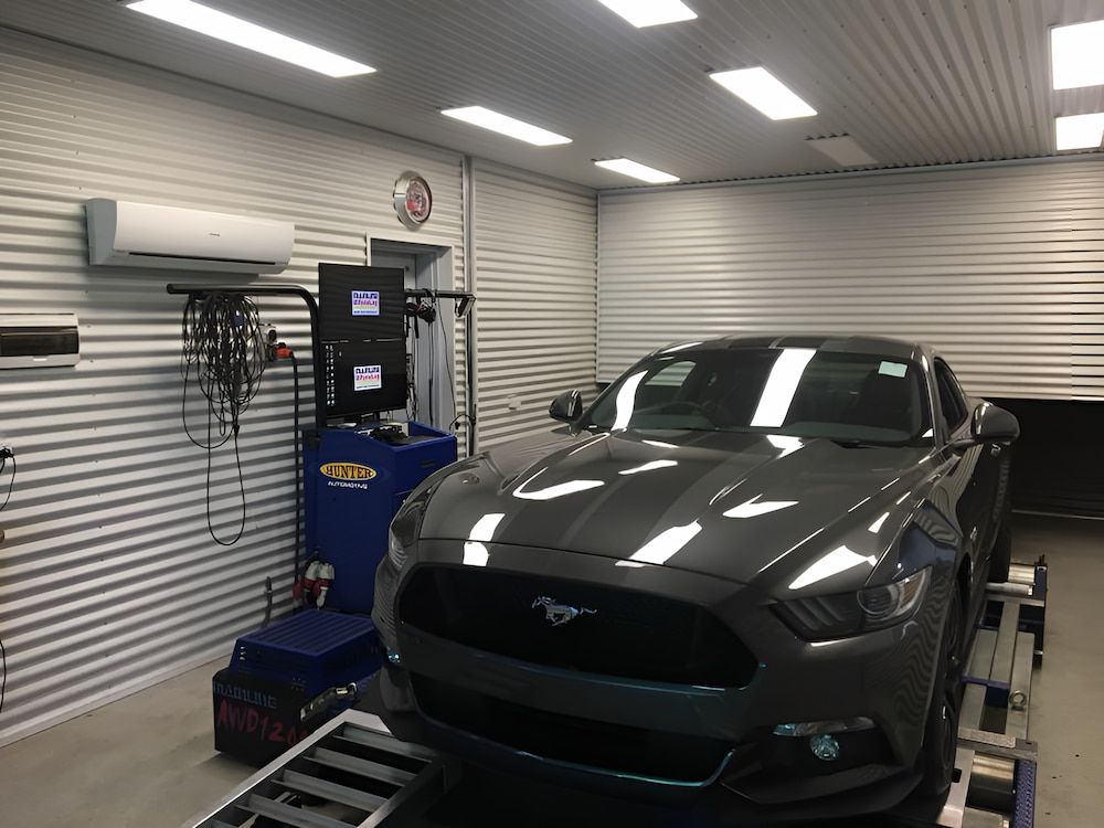 A Gray Mustang Is Parked In A Garage Next To A Machine — Hunter Automotive In Bungalow, QLD
