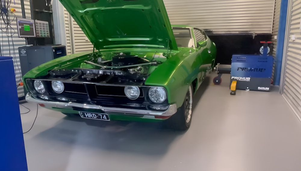 A Green Car With The Hood Up Is Parked In A Garage — Hunter Automotive In Bungalow, QLD