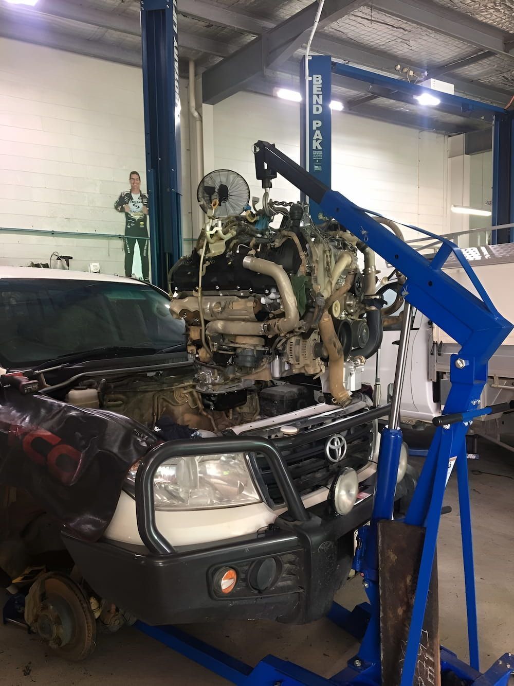 A Car With The Engine Removed Is Sitting On A Lift In A Garage — Hunter Automotive In Bungalow, QLD