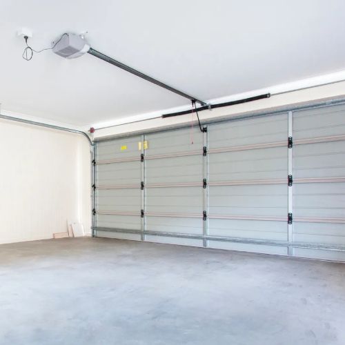 An empty garage with a garage door opener.