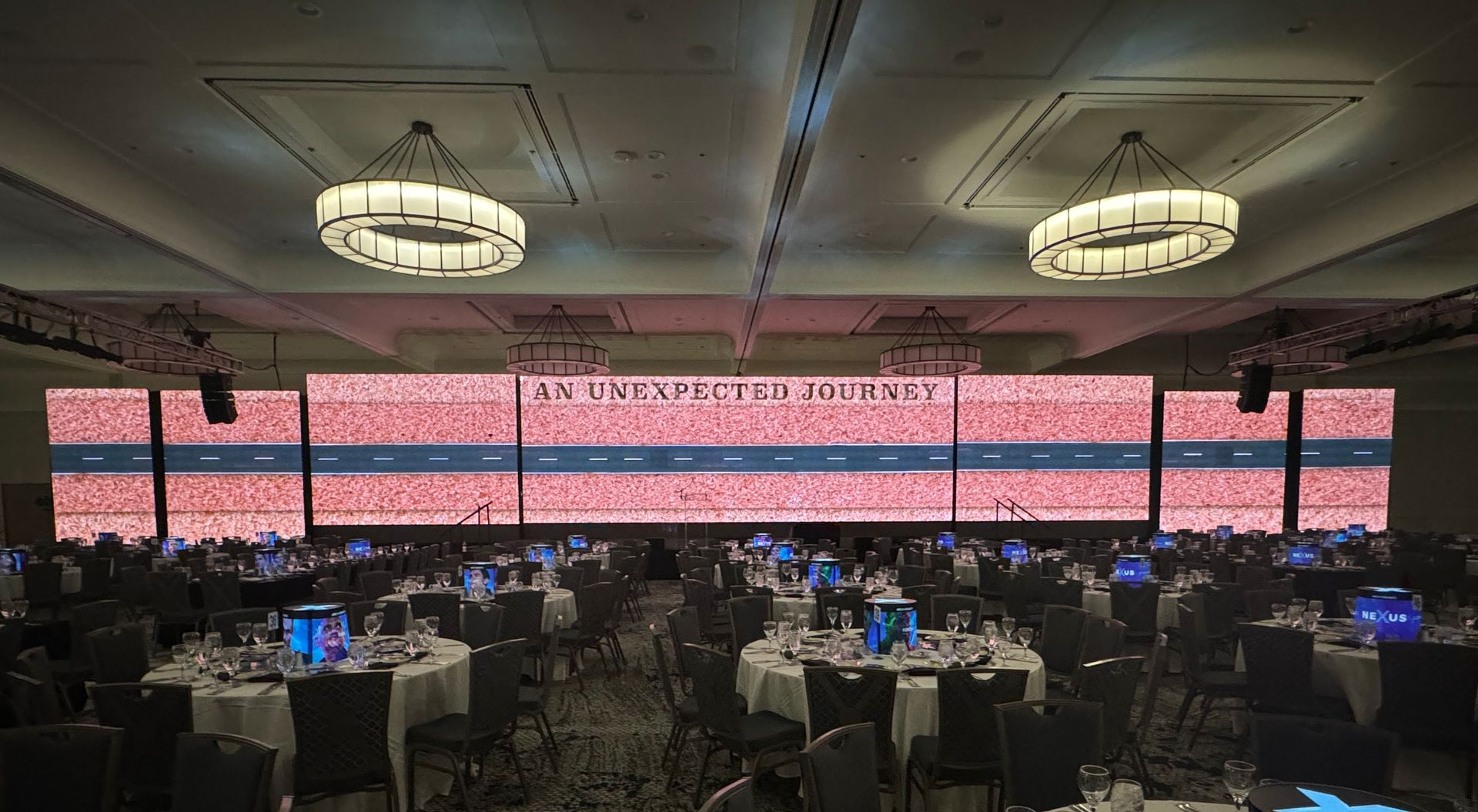 Long LED screen in a conference hall displaying 