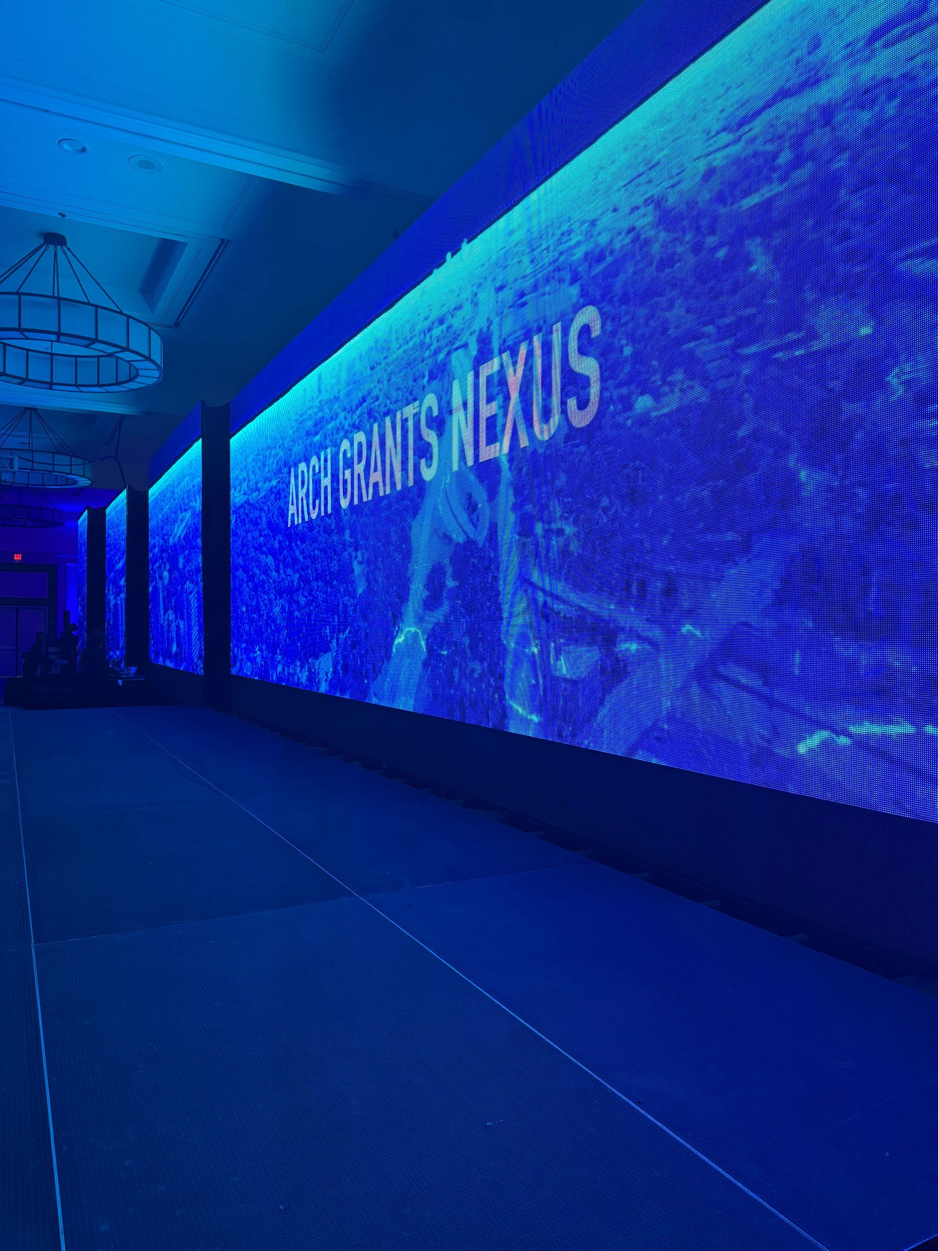 Long LED screen in a conference hall displaying 