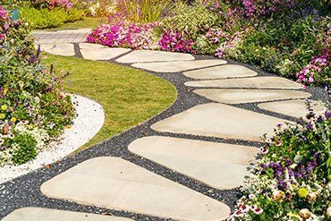Stone Path Winding Through a Garden With Green Grass — CJD Investments (NQ) Pty Ltd in Mackay Harbour, QLD