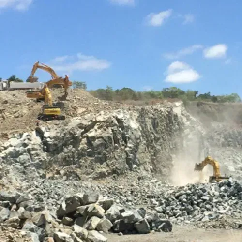 Excavators Working in a Quarry, Extracting Stone Under a Blue Sky — CJD Investments (NQ) Pty Ltd in Mackay Harbour, QLD