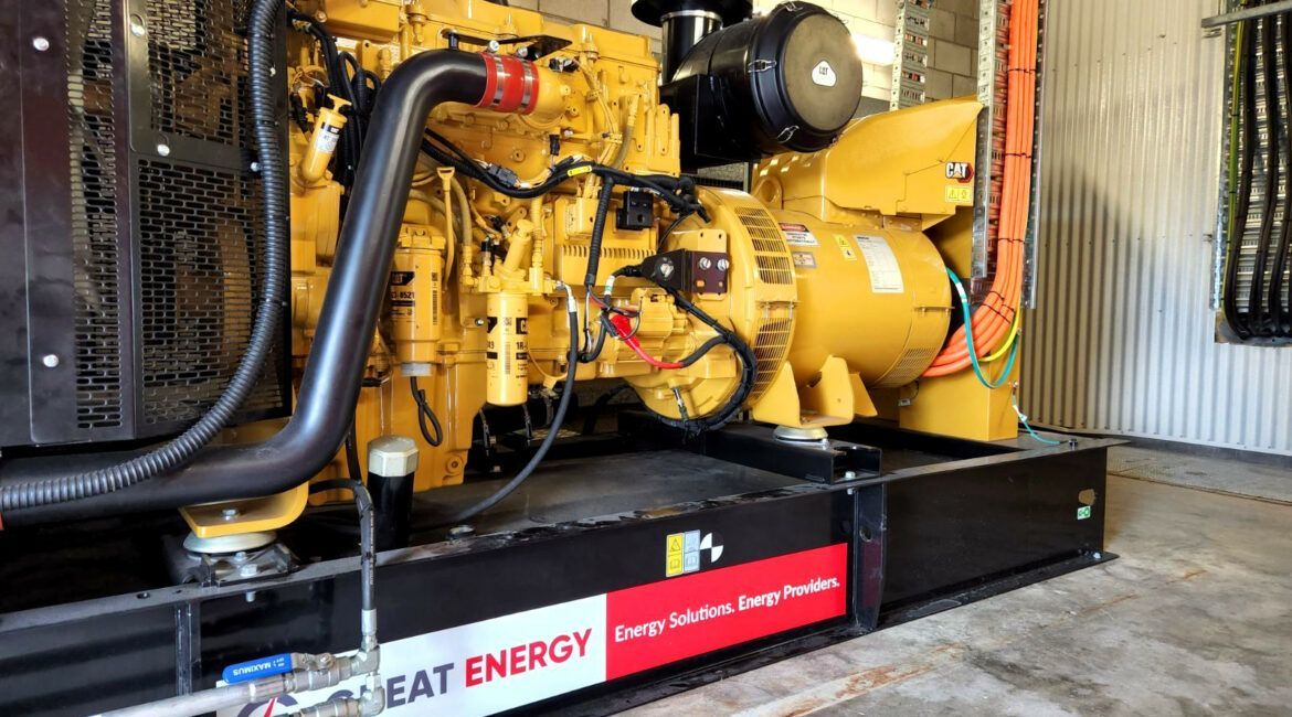 A Large Yellow Diesel Generator Is Sitting In A Room — Great Energy in Portsmith, QLD