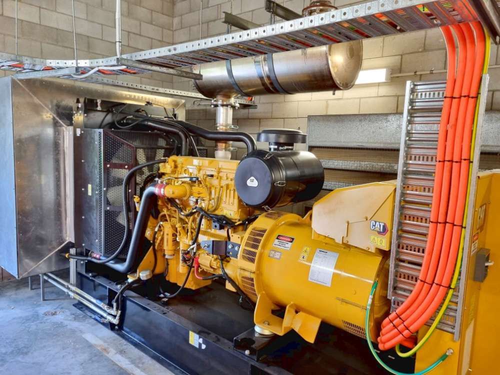 A Large Yellow Generator Is Sitting Inside Of A Building — Great Energy in Cairns, QLD