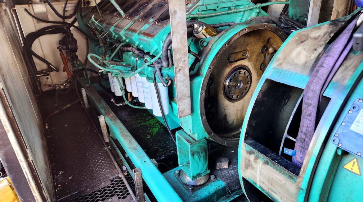 A Green And Black Engine Is Sitting Inside Of A Building — Great Energy in Portsmith, QLD