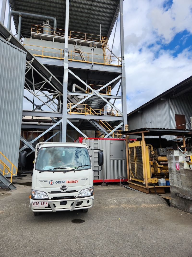 A White Truck Is Parked In Front Of A Large Building — Great Energy in Portsmith, QLD