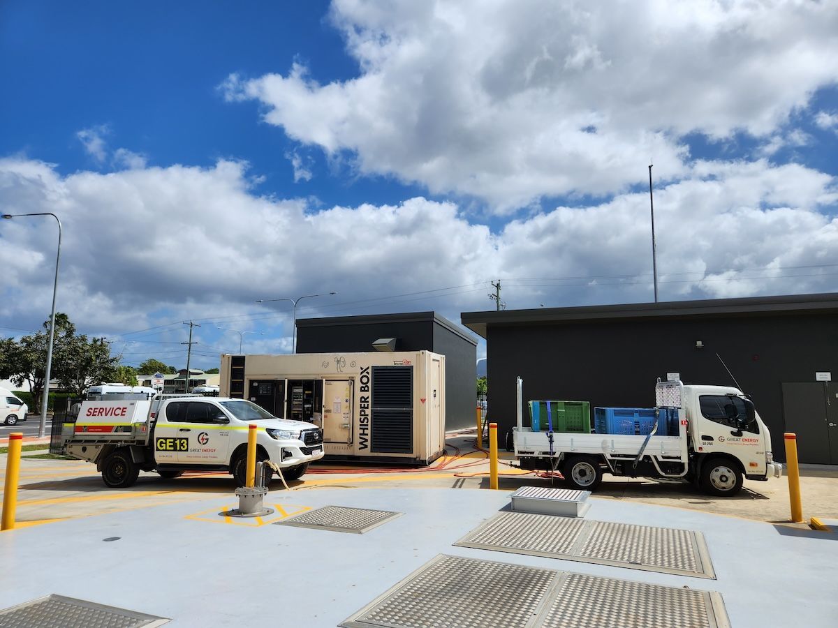 Two Trucks Are Parked In A Parking Lot In Front Of A Building — Great Energy in Portsmith, QLD