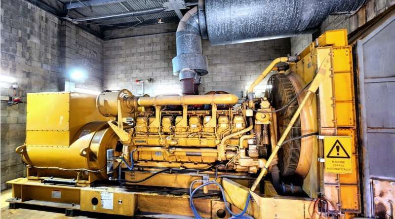 A Large Yellow Engine Is Sitting In A Room — Great Energy in Portsmith, QLD