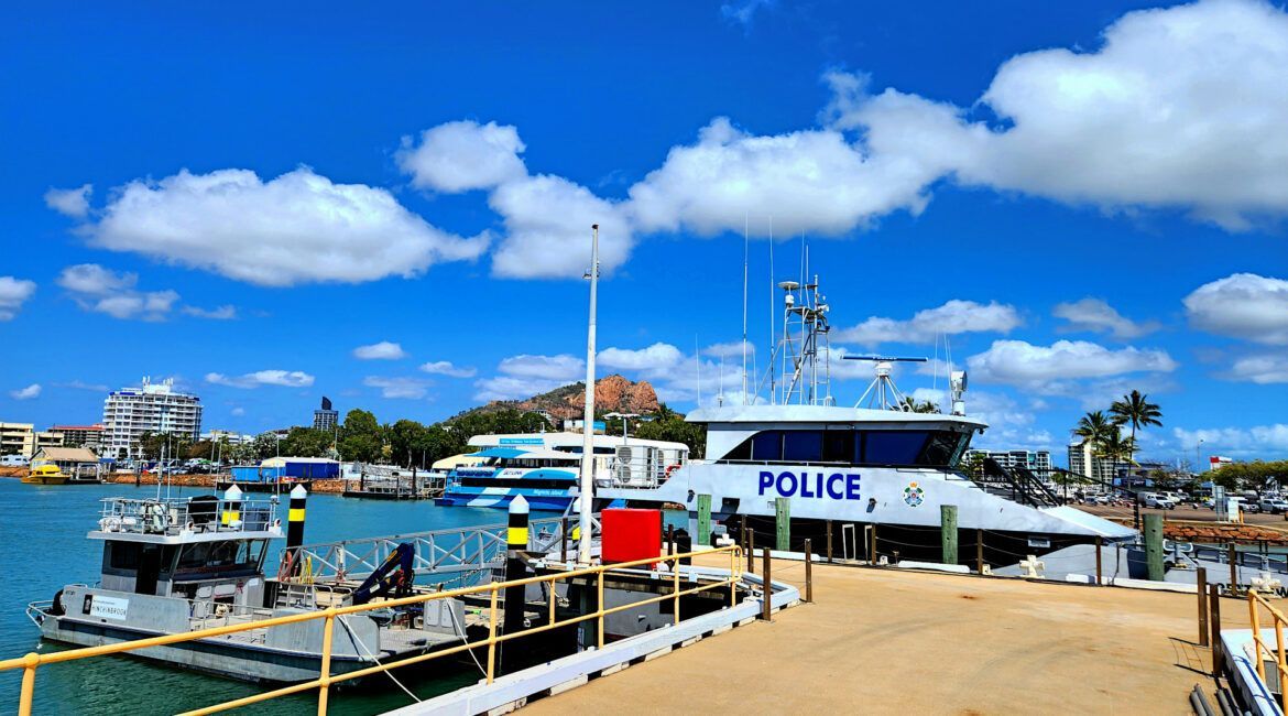 A Police Boat Is Docked At A Dock In The Water — Great Energy in Portsmith, QLD